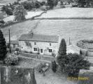 The view taken from Grinton Church tower of one of the cottages on the Harkerside road.